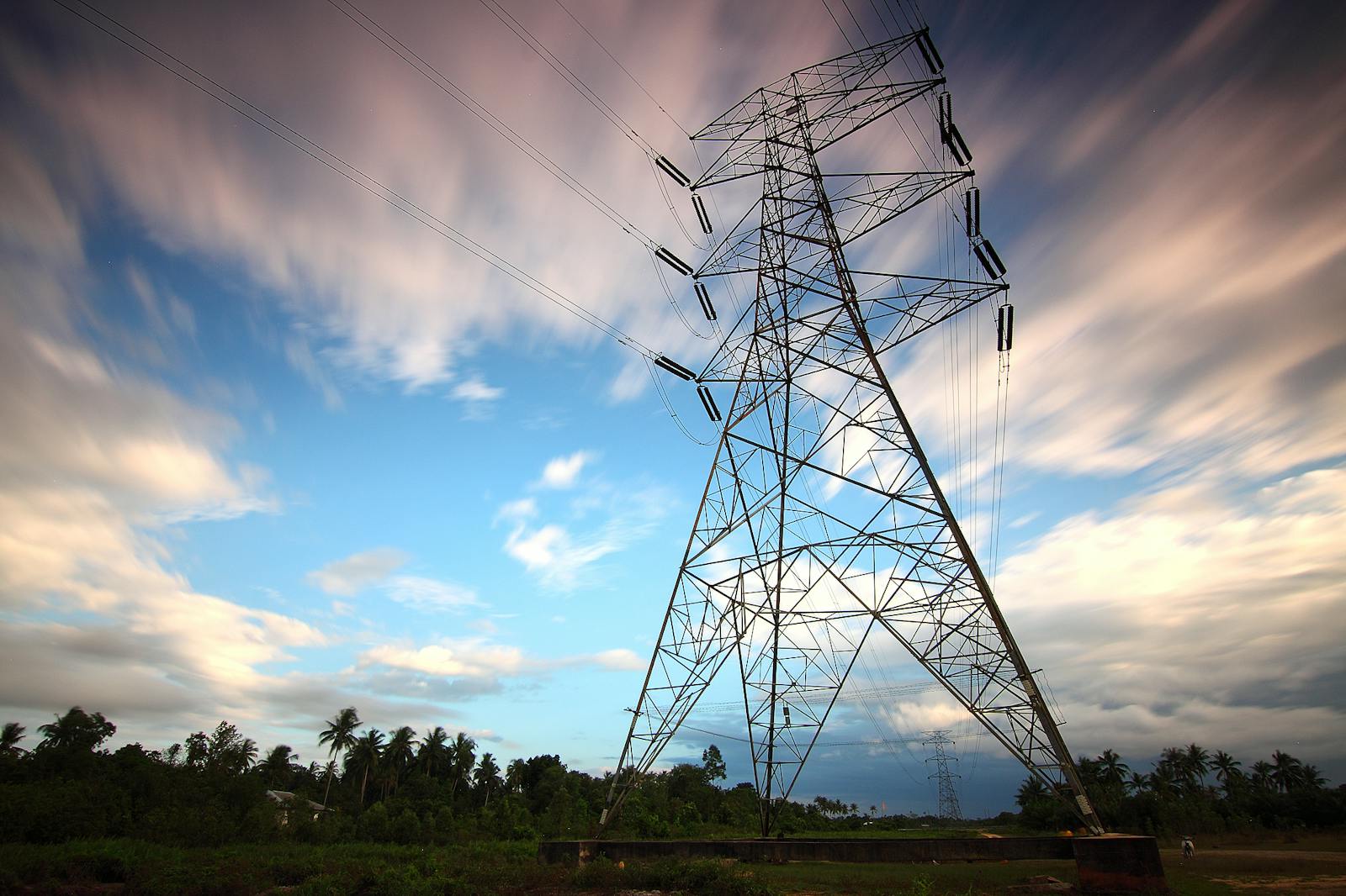 Stunning view of a towering power line against a vibrant sky, showcasing energy infrastructure in nature.