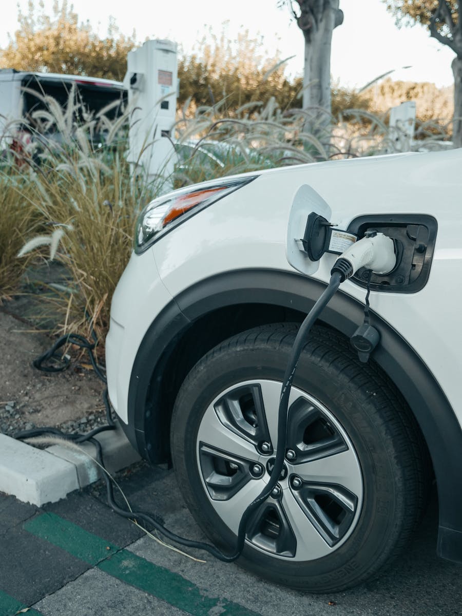 Close-up of an electric vehicle charging at a station, promoting clean energy.